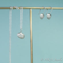 Load image into Gallery viewer, side view of ark clam seashell drop earrings in silver with matching ark clam necklace