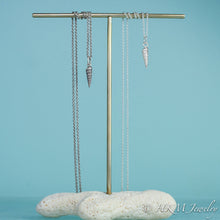 Load image into Gallery viewer, to scale view of auger snail shell necklaces in polished and oxidized silver by hkm jewelry