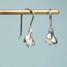 Load image into Gallery viewer, close up side and front view of baby knobbed whelk drop earrings in polished recycled silver by hkm jewelry
