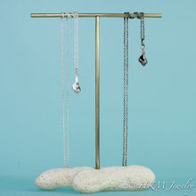 Load image into Gallery viewer, to scale view of baby knobbed whelk necklace in oxidized or polished finish by hkm jewelry