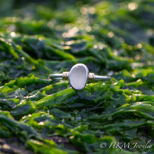 Load image into Gallery viewer, a raw cape may diamond ring with 14k wrapped knot details over silver by hkm jewelry lays in green seaweed
