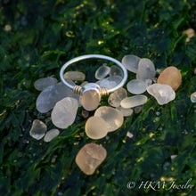 Load image into Gallery viewer, a raw cape may diamond ring with 14k wrapped knot details over silver by hkm jewelry lays in a pile of beach stones