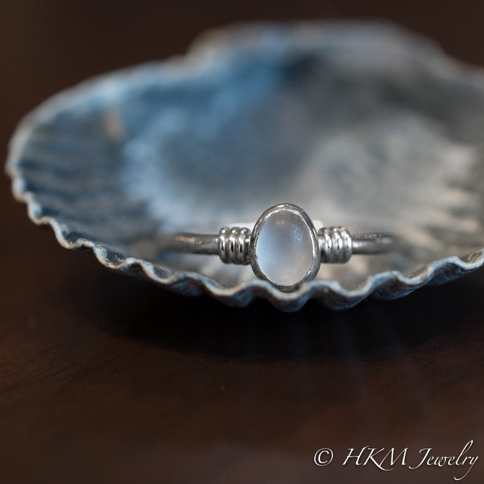 raw cape may diamond ring with knot detail by hkm jewelry laying in scallop shell