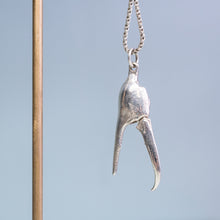 Load image into Gallery viewer, open pincer view of the cast fiddler crab claw necklace in recycled silver hanging from brass and coral necklace display on a blue background by hkm jewelry