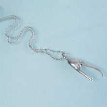 Load image into Gallery viewer, cast fiddler crab claw in recycled silver laying on a blue background by hkm jewelry