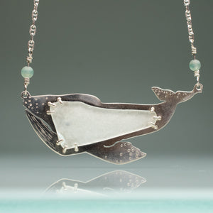 close up of grey whale necklace in sterling silver and sea glass with aventurine beads and anchor chainby hkm jewelry