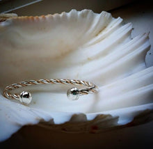 Load image into Gallery viewer, viking style twisted rope cuff in silver and 14k gold displayed inside a shell by Hali MacLaren of hkm jewelry