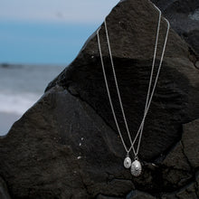 Load image into Gallery viewer, limpet shell necklaces cast in silver photographed on jetty rocksby hkm jewelry