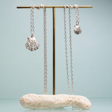 Load image into Gallery viewer, large and small lions paw scallop shell necklaces in polished sterling silver on coral and brass jewelry stand by hkm jewelry