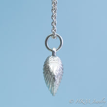 Load image into Gallery viewer, The Little Neck Clam Necklace is made from the molding and casting of a real "clam seed" in solid recycled silver by HKM Jewelry side view with stamping