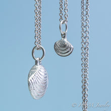 Load image into Gallery viewer, The Little Neck Clam Necklace is made from the molding and casting of a real "clam seed" in solid recycled silver by HKM Jewelry side view with stamping