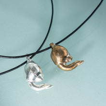 Load image into Gallery viewer, cast silver and bronze lucky bone horseshoe crab claw necklace on leather cord by hali maclaren of hkm jewelry