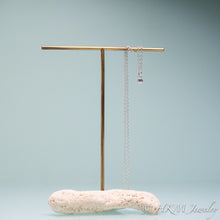 Load image into Gallery viewer, mini clam seashell necklace cast in silver on silver chain and coral necklace stand by hali maclaren of hkm jewelry