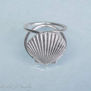 close up angled top view of large scallop shell ring on a double band in sterling silver by hkm jewelry
