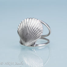 Load image into Gallery viewer, close up angled front view of large scallop shell ring on a double band in sterling silver by hkm jewelry
