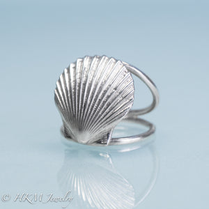 close up angled front view of large scallop shell ring on a double band in sterling silver by hkm jewelry