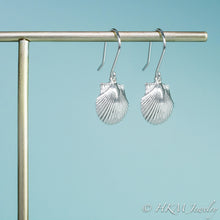 Load image into Gallery viewer, close up side view of the small polished scallop shell dangle earrings in sterling silver by hkm jewelry
