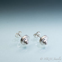 Load image into Gallery viewer, Side view of the Channeled Whelk Top Studs in sterling silver with Biggie Ear Nut Backs by Hali MacLaren of HKM Jewelry on blue ombre background.