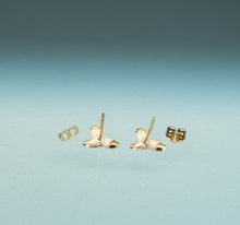 Load image into Gallery viewer, Gold earrings on a light blue background
