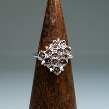 Load image into Gallery viewer, northern star coral cast in oxidized recycled silver and prong set in a ring by hkm jewelry on a wooden ring stand
