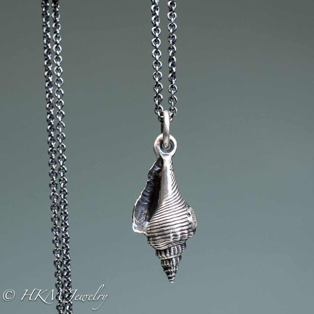 front view of fl fighting conch shell necklace in oxidized sterling silver by hkm jewelry