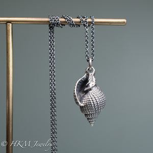 front view of close up view of cast silver nutmeg shell necklace in an oxidized finish by hkm jewelry