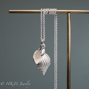 front view of close up view of cast silver nutmeg shell necklace in a polished finish by hkm jewelry