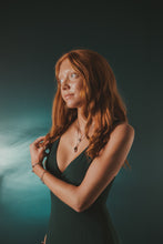 Load image into Gallery viewer, Female, red-head, kitten’s paw ring, viking rope cuff, life saver cuff, sharp-ribbed drill necklace, queen conch necklace, green/blue, teal, underwater background

