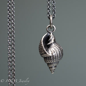 close up front view cast silver nutmeg shell necklace in an oxidized finish by hkm jewelry