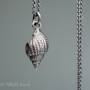close up back view cast silver nutmeg shell necklace in an oxidized finish by hkm jewelry