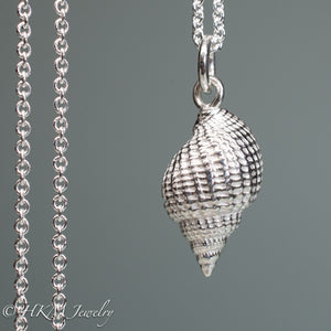 close up back view cast silver nutmeg shell necklace in a polished finish by hkm jewelry