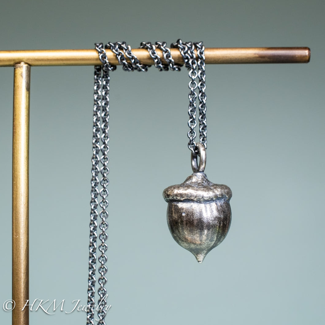 cast silver acorn necklace by hkm jewelry in oxidized finish