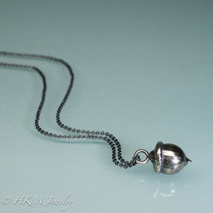 cast silver acorn necklace by hkm jewelry in oxidized finish