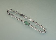 Load image into Gallery viewer, A silver chain bracelet featuring a polished, irregular-shaped light green stone centerpiece, displayed on a light gray background.
