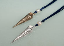 Load image into Gallery viewer, oranments with shell-shaped pendants and pearls on a light gray background
