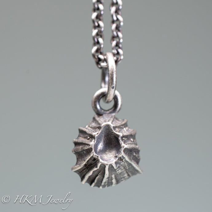 close up view of cast silver barnacle necklace in oxidized finish by hkm jewelry