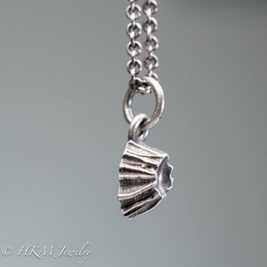 close up side view of cast silver barnacle necklace in oxidized finish by hkm jewelry