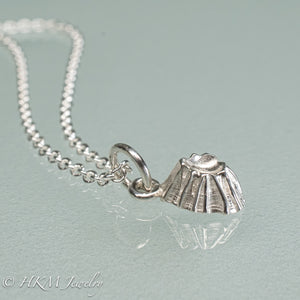 close up side view of cast silver barnacle necklace in polished finish by hkm jewelry