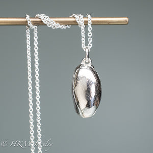 back view of cast atlantic bubble shell bulla striata necklace in polished sterling silver by hkm jewelry