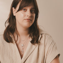 Load image into Gallery viewer, Woman wearing layered necklaces against a neutral background
