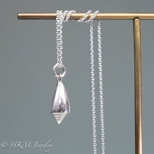 Load image into Gallery viewer, back view of florida cone snail necklace in polished silver finish by hkm jewelry
