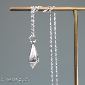 back view of florida cone snail necklace in polished silver finish by hkm jewelry