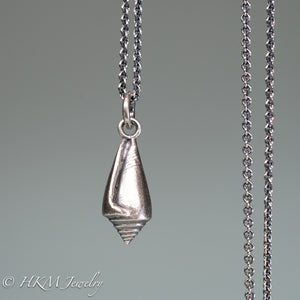 front close up view of florida cone snail necklace in oxidized silver finish by hkm jewelry