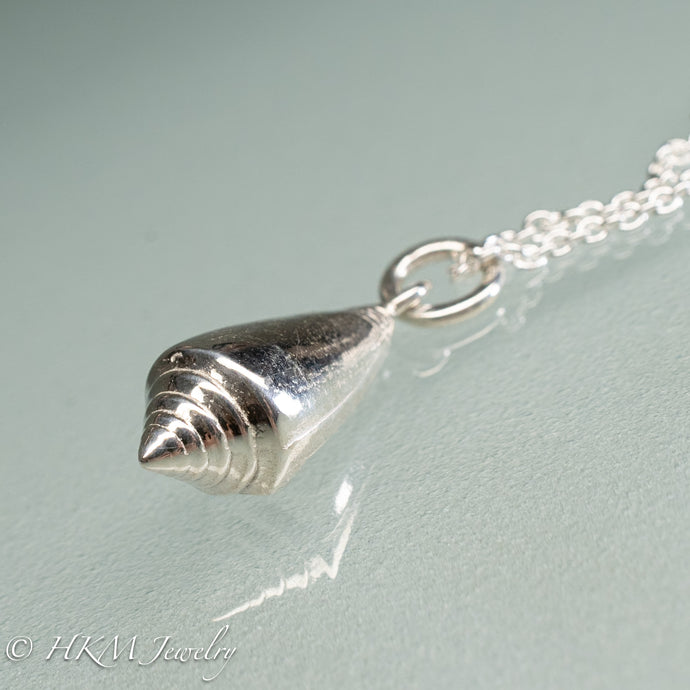 top view of florida cone snail necklace in polished silver finish by hkm jewelry
