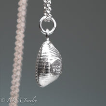 Load image into Gallery viewer, sideview of cast silver cowrie shell by hkm jewelry
