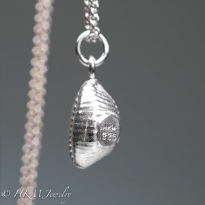 sideview of cast silver cowrie shell by hkm jewelry