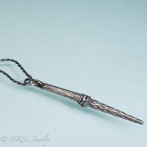 close up tulip tree flower fairy sword necklace in cast sterling silver by hkm jewelry in oxidized finish