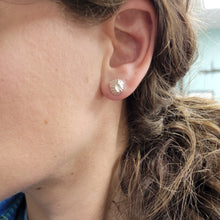 Load image into Gallery viewer, front view of cast silver fossil barnacle stud earrings in polished sterling silver on model by hkm jewelry
