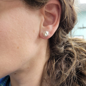 front view of cast silver fossil barnacle stud earrings in polished sterling silver on model by hkm jewelry