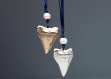 Load image into Gallery viewer, Two shark tooth ornaments on blue cords with white beads against a gray background
